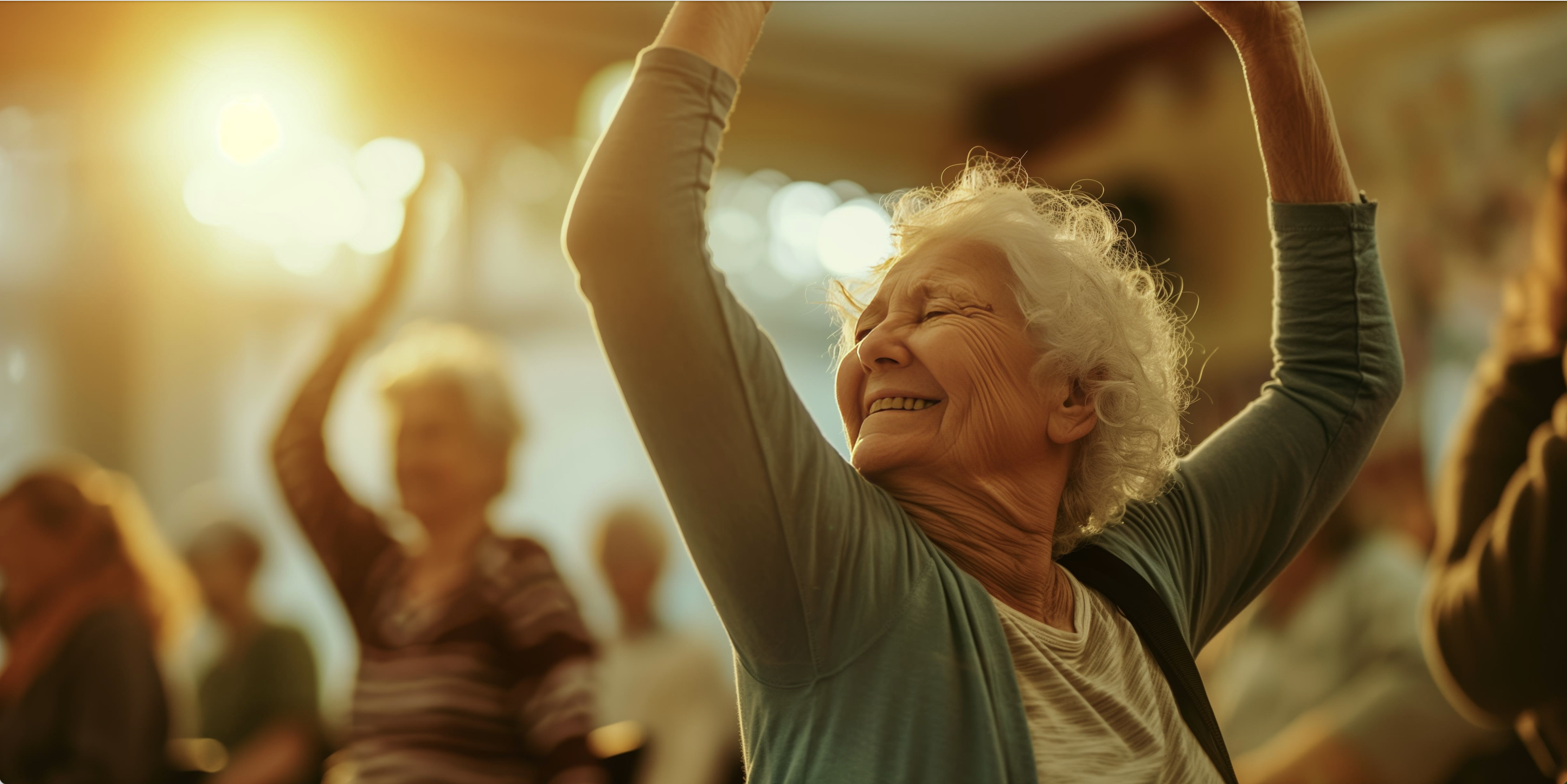 Smiling older woman with arms raised in a yoga pose