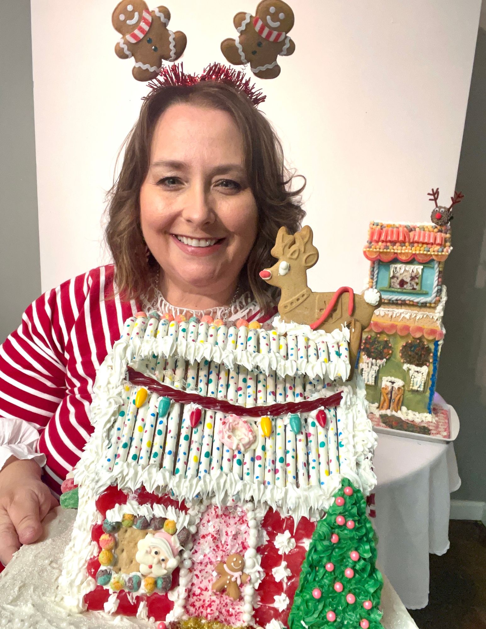 Woman holding a gingerbread house