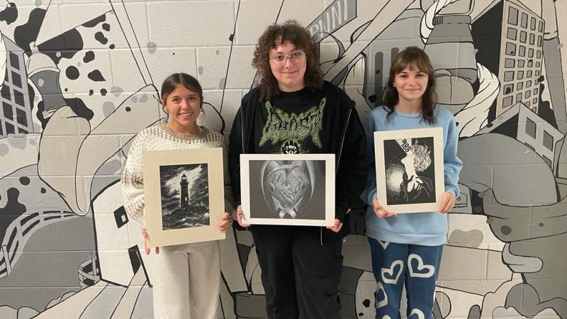 Kids holding drawings 